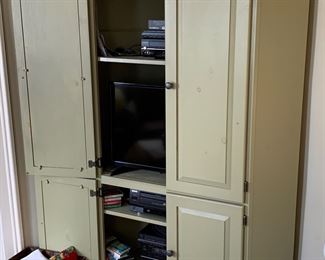Vintage corner cabinet currently being used as an entertainment center 