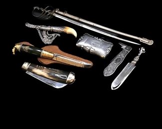  Imperial German model sword, a Victorian folding fruit knife, an antique sterling tooth pendant, a sterling silver match-safe, a Finland Puukko knife, a British sterling silver eagle claw bookmark