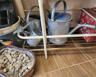 watering cans and assorted gardening items
