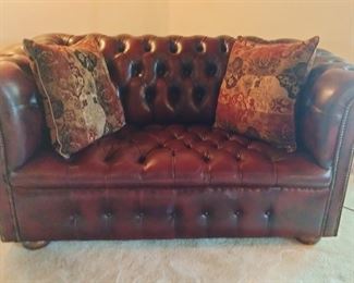 Tufted leather love seat 