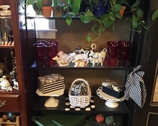 Vintage picnic baskets, vintage cow creamers, ruby red glass wear, plants, etc