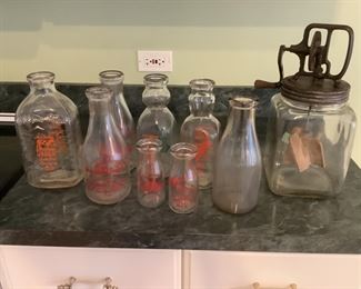 Variety of dairy bottles and butter churn