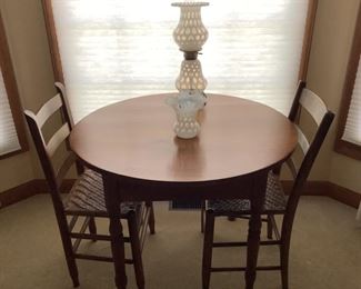 Cherry round table with four chairs.  Measures 35” round .  $175