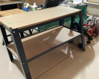 Steel and press board work bench. Measures 30 h x 23” d x 26” w.