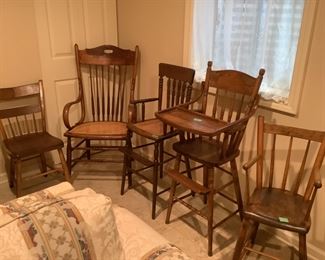 Multiple antique chairs, rocker and high chair