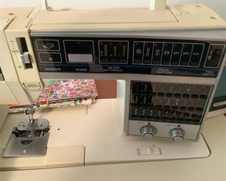 Singer sewing machine with parts….in a cabinet
