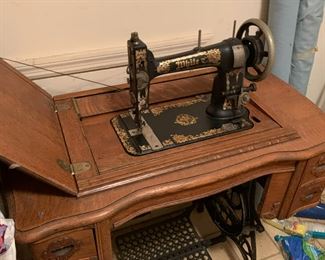 #52 White treadle sewing machine in oak case $125.00