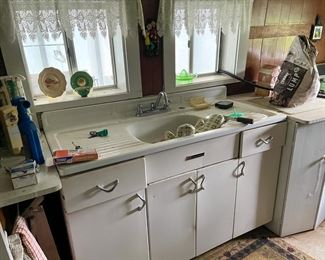 vintage metal kitchen cabinets and old porcelain farmhouse sink...depression glass juicer