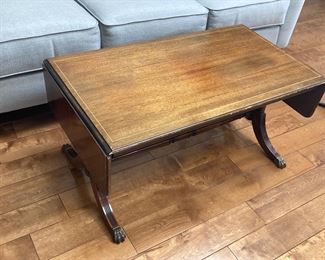 1950s wooden table with metal claw feet covers - two sides come up to extend length 