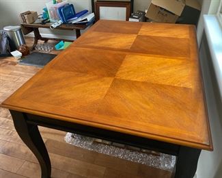 Wood dining table - no chairs. Comes with leaf which extends it by 1.5 feet. 