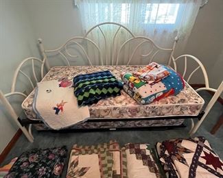Daybed with trundle, lots of nice quilt sets and blankets