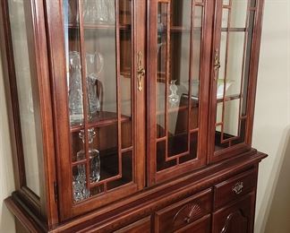 Cherry Breakfront and matching dining table. [Not pictured here]. Has lighted top and plenty of storage. The table comes with 2 extension leaves and high-quality protective pads for the whole thing. Two armed chairs and 4 more complete the set.