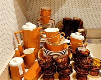 [Attributed to Homer Laughlin] beautiful dish set. 50+ pieces including coffee/tea pot, creamer/sugar, salt/pepper, butter dish and gravy boat. 2 serving platters and 2 casserole dishes. Plus the place settings: plates, salads, bowls, cups, saucers. Matching water glasses, custard glasses and juice glasses. A rare find for fun entertainment. 