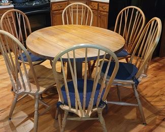 Terrific oak drop leaf table and 6 chairs. 42" when fully extended. 
