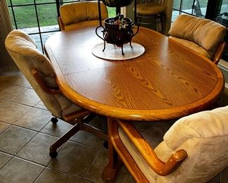 Vintage oak kitchen table with 4 rolling upholstered chairs (1 leaf)
