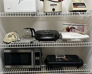 Kitchen appliances including The Bread Maker, Crock-Pot, Chefman indoor grill, Black & Decker microwave, FryDaddy Hot and Fresh Popcorn Maker and more 