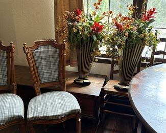 Two more side chairs with wall decor in background