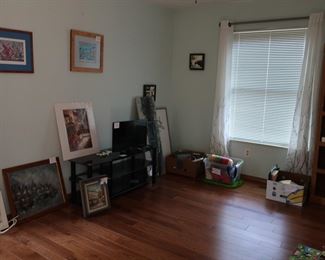 view  of  another  bedroom with art, purses,  frames,  curtains