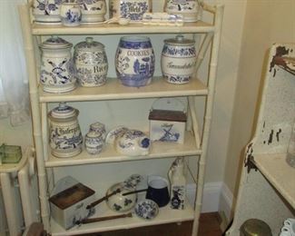 Distressed white shelving unit hold pretty collection of vintage blue and white china including salt boxes, salt & pepper