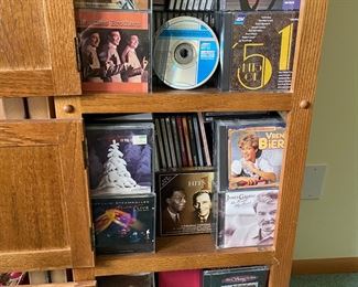 Hundreds of CD's in a nice wooden cabinet