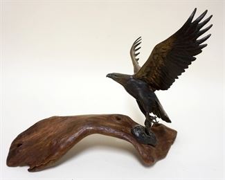 1129	BRONZE EAGLE ON WOOD BASE, APPROXIMATELY 15 IN X 11 1/2 IN HIGH
