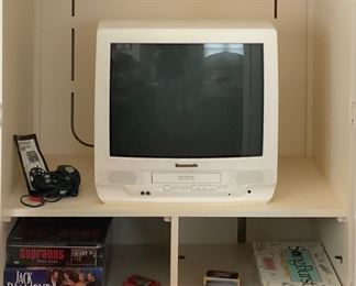 Interior Riverside Furniture Company White 2-Door Armoire/Entertainment Center shown with Panasonic Omnivision VHS/FM Radio 21”TV MD# PV-C2031W and Assorted Games