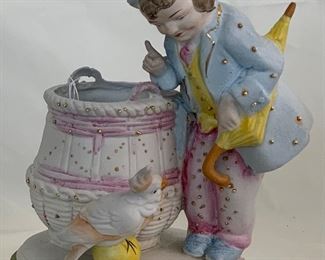 Porcelain Bisque Hand Decorated Boy with in Top Hat with Umbrella Standing by Basket Barrel Scolding a Cockatiel (6.5”H x 5”W X 3.5” D)