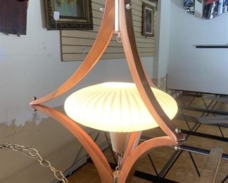 Mid century modern flying saucer chandelier, teakwood with brass, milk glass shade. Swag style, easily converted to hardwire. Measures 32" h.  