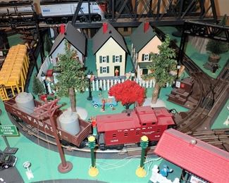 FULL TOWN WITH 3 TRAINS RUNNING THUR IT - WITH BUILDING - VEHICALS - TREES - PEOPLE - BASEBALL FIELD & PLAYERS - TRAIN STATION - TRAIN WITH FULL CARS - LOGS - ANIMALS - ETC.