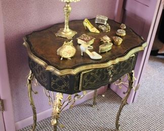Decorative ebonized and gilt side table