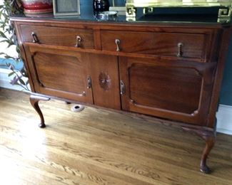 Antique refinished breakfront with ample storage for bareware.