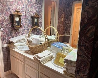 Assorted linens and towels, unique clock