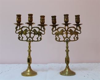 Lovely pair of old brass candelabra with silhouettes of lions