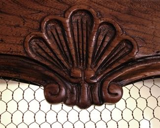 Detail of carving on the Baker Furniture Company hand carved French Provincial style lighted display cabinet in like new condition