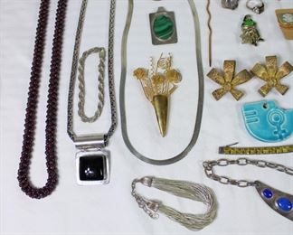 Close up of garnet beads and sterling silver necklaces and bracelet