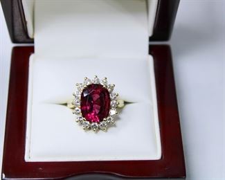 Approximately 6 1/2 to 7 carat tourmaline in 18K yellow gold with 1 carat of diamonds surrounding it