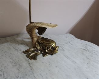 Another view of the Chapman Lamp, a figural dolphin form with a ram's horn body and a brass head and tail.  