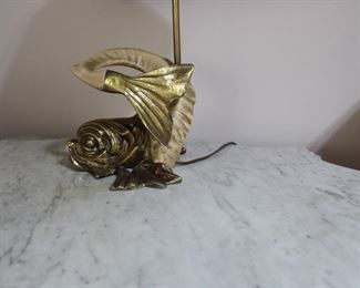 Another view of the Chapman Lamp, a figural dolphin form with a ram's horn body and a brass head and tail.  