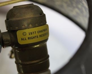 Label on the Chapman Lamp, a figural dolphin form with a ram's horn body and a brass head and tail.  