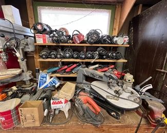 Shelves or electric had routers drills and other specialty power tools.