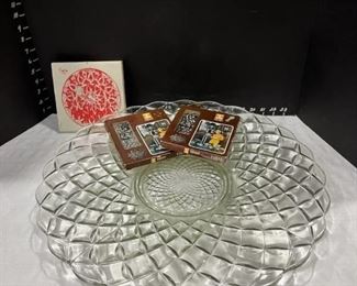 Large glass serving platter with three trivets