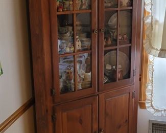 solid pine corner cabinet full of collectibles and dishware