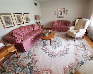 Living room French wool full size rug, camel back sofa, matching love seat, wing chairs, oak end and coffee tables, floral art