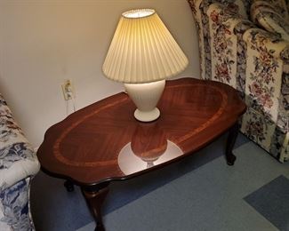 walnut and mahogany coffee table, floral and striped loveseats