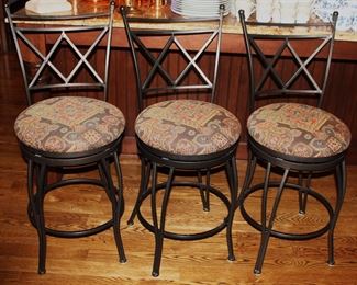 Swivel stools with tapestry fabric seats.