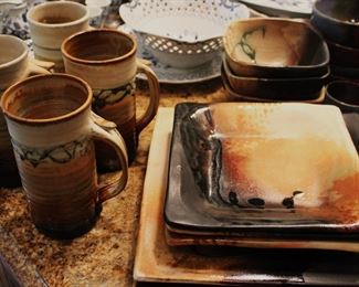 Signed pottery dishware set.