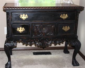 This wonderful dresser is elegantly carved, made of solid wood and has brass studs and furnishings.