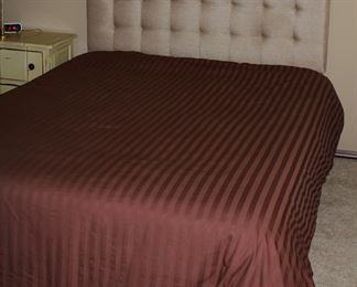 Fabric tufted upholstered queen headboard and bed.