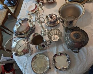 Several silver service items. platter, champagne bucket, ice bucket, pitcher, candy dish, candle holder.