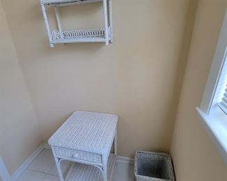 White wicker end table, wall shelf and wastebasket